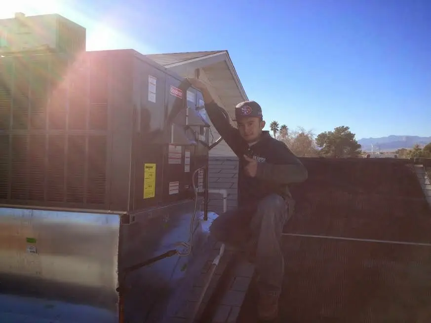 HVAC technician performing HVAC Inspection on a rooftop unit in Capitola